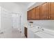 Laundry room features washer, dryer, cabinets and access to other rooms at 329 Savona Way, North Venice, FL 34275