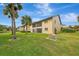 Exterior view of condo building, showcasing landscaping at 340 Three Lakes Ln # O, Venice, FL 34285