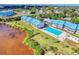 Aerial view of waterfront community pool and surrounding buildings at 4410 Warren Ave # 214, Port Charlotte, FL 33953