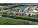 An aerial view of a community featuring lush landscaping, water features, and tile roofs, highlighting the desirable location at 594 Sawgrass Bridge Rd, Venice, FL 34292