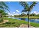 Beautiful backyard view of landscaping with a large water feature at 594 Sawgrass Bridge Rd, Venice, FL 34292