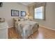 Bedroom showcasing a queen-sized bed with decorative pillows, complemented by a side table and wood floors at 594 Sawgrass Bridge Rd, Venice, FL 34292