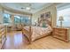 Serene bedroom with hardwood floors, ceiling fan, and natural light at 594 Sawgrass Bridge Rd, Venice, FL 34292