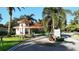 The community entrance gate with lush tropical landscaping welcomes residents and guests at 594 Sawgrass Bridge Rd, Venice, FL 34292