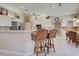 Open kitchen with counter seating, stainless steel appliances, and modern lighting at 594 Sawgrass Bridge Rd, Venice, FL 34292