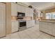 Well-equipped kitchen with stainless steel appliances, ample cabinet space, and tile floors at 594 Sawgrass Bridge Rd, Venice, FL 34292