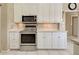 Kitchen featuring stainless steel oven and microwave and a tiled backsplash at 594 Sawgrass Bridge Rd, Venice, FL 34292