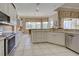 Bright kitchen with white cabinets, stainless steel appliances, and ample counter space at 594 Sawgrass Bridge Rd, Venice, FL 34292