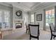 Bright living room features fireplace, tray ceiling, and plenty of light at 594 Sawgrass Bridge Rd, Venice, FL 34292