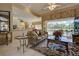 Spacious living room with pool access and an open floor plan to the kitchen and breakfast nook at 594 Sawgrass Bridge Rd, Venice, FL 34292