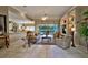 Spacious living room featuring tile floors, a ceiling fan, and a view of the pool area at 594 Sawgrass Bridge Rd, Venice, FL 34292