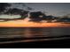 Beautiful sunset over the tranquil ocean, casting a warm golden glow on the water and clouds at 594 Sawgrass Bridge Rd, Venice, FL 34292