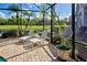 Charming screened lanai featuring comfortable seating, perfect for enjoying the views and fresh air at 594 Sawgrass Bridge Rd, Venice, FL 34292