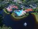 An aerial shot of the community clubhouse showcasing a resort-style pool and well-maintained landscaping at 594 Sawgrass Bridge Rd, Venice, FL 34292