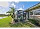 The home's screened pool is surrounded by mature landscaping and is adjacent to a tranquil water feature at 594 Sawgrass Bridge Rd, Venice, FL 34292