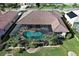Aerial view of screened pool with mature landscaping, offering a private and relaxing outdoor living space at 594 Sawgrass Bridge Rd, Venice, FL 34292