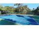 Well-maintained tennis court surrounded by lush landscaping at 594 Sawgrass Bridge Rd, Venice, FL 34292