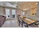 Dining area with a large table, chairs, and access to the back patio and pool area at 5280 E Sunnydale Cir, Sarasota, FL 34233