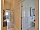 Bright hallway with laundry area and additional room access at 5280 E Sunnydale Cir, Sarasota, FL 34233