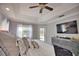 Main bedroom with king-size bed, access to backyard, and large TV at 5280 E Sunnydale Cir, Sarasota, FL 34233