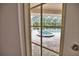 Relaxing view of a refreshing pool from interior French doors at 5280 E Sunnydale Cir, Sarasota, FL 34233