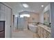 Elegant bathroom with soaking tub, walk-in shower, and double vanity at 5280 E Sunnydale Cir, Sarasota, FL 34233