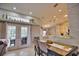 Bright dining room with a view of the kitchen and access to the back patio and pool area at 5280 E Sunnydale Cir, Sarasota, FL 34233