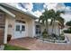 Front entry with double doors, stonework, and landscaping at 5280 E Sunnydale Cir, Sarasota, FL 34233