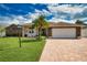 House exterior features stone accents and a brick driveway at 5280 E Sunnydale Cir, Sarasota, FL 34233