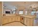Open concept kitchen with island, stainless steel appliances, and light cabinets at 5280 E Sunnydale Cir, Sarasota, FL 34233