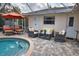 Relaxing pool area with patio furniture and a covered patio at 5280 E Sunnydale Cir, Sarasota, FL 34233
