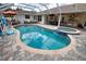 Inviting kidney-shaped pool with a built in spa at 5280 E Sunnydale Cir, Sarasota, FL 34233