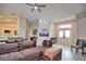Bright living room with a sectional sofa, built-in aquarium, and double doors leading outside at 5280 E Sunnydale Cir, Sarasota, FL 34233