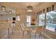 Breakfast nook with glass-top table and view of pool and lanai at 5280 E Sunnydale Cir, Sarasota, FL 34233