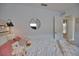 Serene bedroom with plush bedding and a round mirror at 5280 E Sunnydale Cir, Sarasota, FL 34233