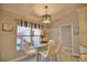 Bright breakfast nook features glass table and four chairs, offering a view of the backyard at 5280 E Sunnydale Cir, Sarasota, FL 34233