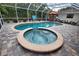 Inviting kidney-shaped pool and spa with brick pavers at 5280 E Sunnydale Cir, Sarasota, FL 34233