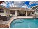 Relaxing pool and spa area with covered patio at 5280 E Sunnydale Cir, Sarasota, FL 34233