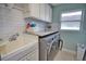 Laundry room with washer, dryer, and built-in cabinets at 5280 E Sunnydale Cir, Sarasota, FL 34233