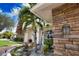 Landscaped entryway with stone accents and palm trees at 5280 E Sunnydale Cir, Sarasota, FL 34233