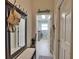 Hallway with mirror and laundry room access at 5280 E Sunnydale Cir, Sarasota, FL 34233