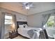 Bright bedroom with a queen-size bed, nightstand, and ample window light at 5280 E Sunnydale Cir, Sarasota, FL 34233