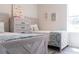 Charming bedroom featuring twin beds and a dresser, creating a peaceful and comfortable space at 17501 Belle Eden Way, Nokomis, FL 34275