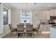 Light and airy dining room with a six-person table and chandelier at 253 Calmar Way, Nokomis, FL 34275