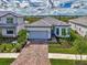 Modern home with gray garage door and landscaping at 6066 Talon Preserve Dr, Nokomis, FL 34275