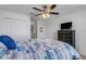 Bedroom with queen bed, dresser, and ceiling fan at 19304 Bluff Dr, Venice, FL 34292