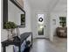 Bright entryway with a black console table, mirror, and wreath at 19304 Bluff Dr, Venice, FL 34292