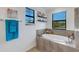 Bathroom with a soaking tub, walk-in shower, and large window at 19304 Bluff Dr, Venice, FL 34292