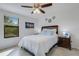 Bedroom with queen bed, nightstand, and ceiling fan at 19304 Bluff Dr, Venice, FL 34292