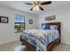 Bright bedroom with a queen-size bed and nautical-themed bedding at 19304 Bluff Dr, Venice, FL 34292